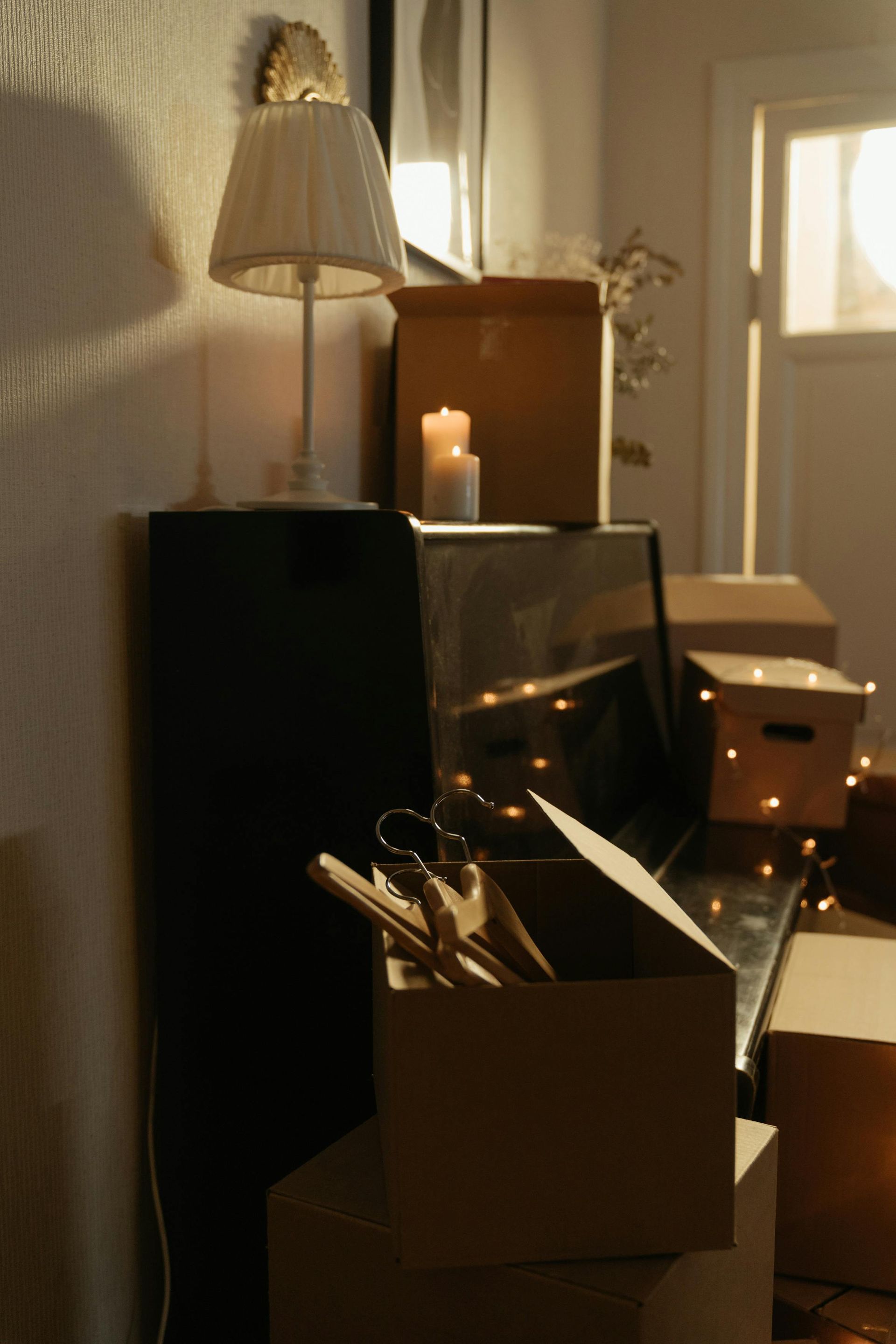 A living room filled with cardboard boxes and a lamp — Roderick Removals & Van Lines In Gladstone Central, QLD
