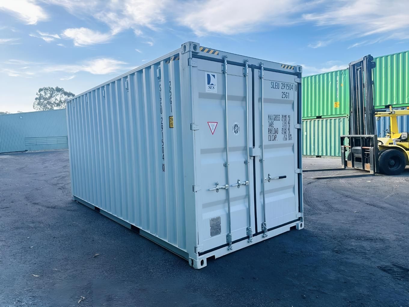 A White Container is Sitting in a Parking Lot Next to a Forklift — Roderick Removals & Van Lines In Gladstone Central, QLD