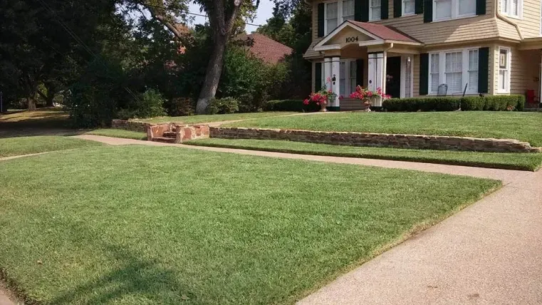 A large house with a lush green lawn in front of it.