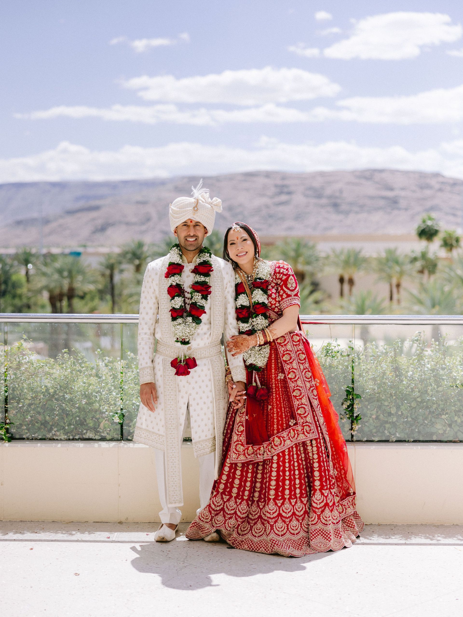 A bride and groom are posing for a picture on their wedding day.