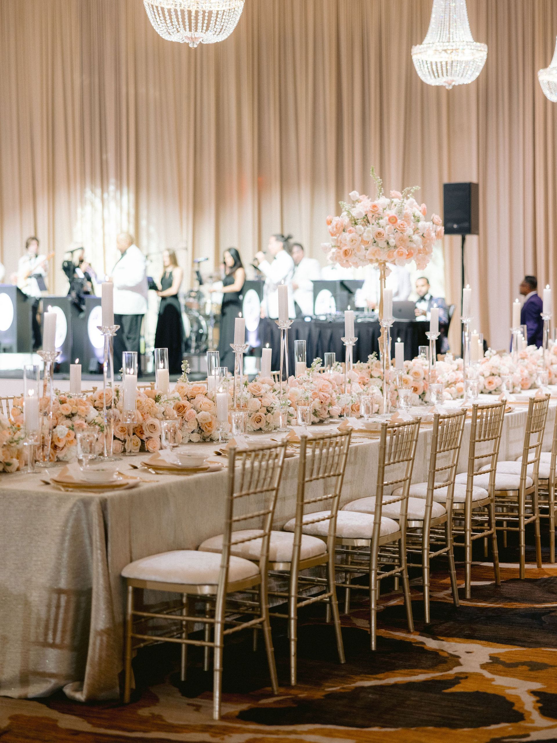 A large room with tables and chairs set up for a wedding reception.