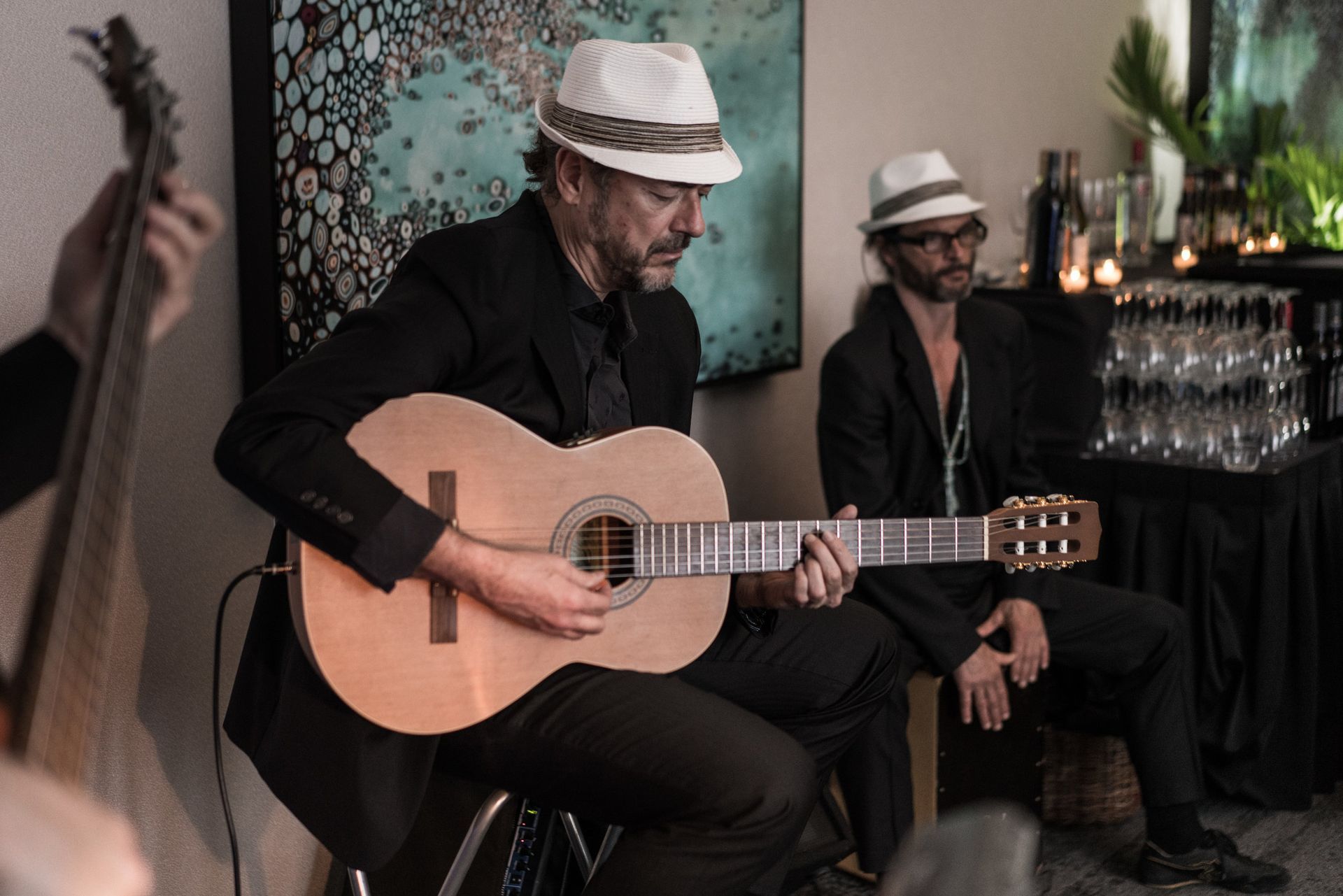 Latin guitarist playing live music at cigar bar lounge