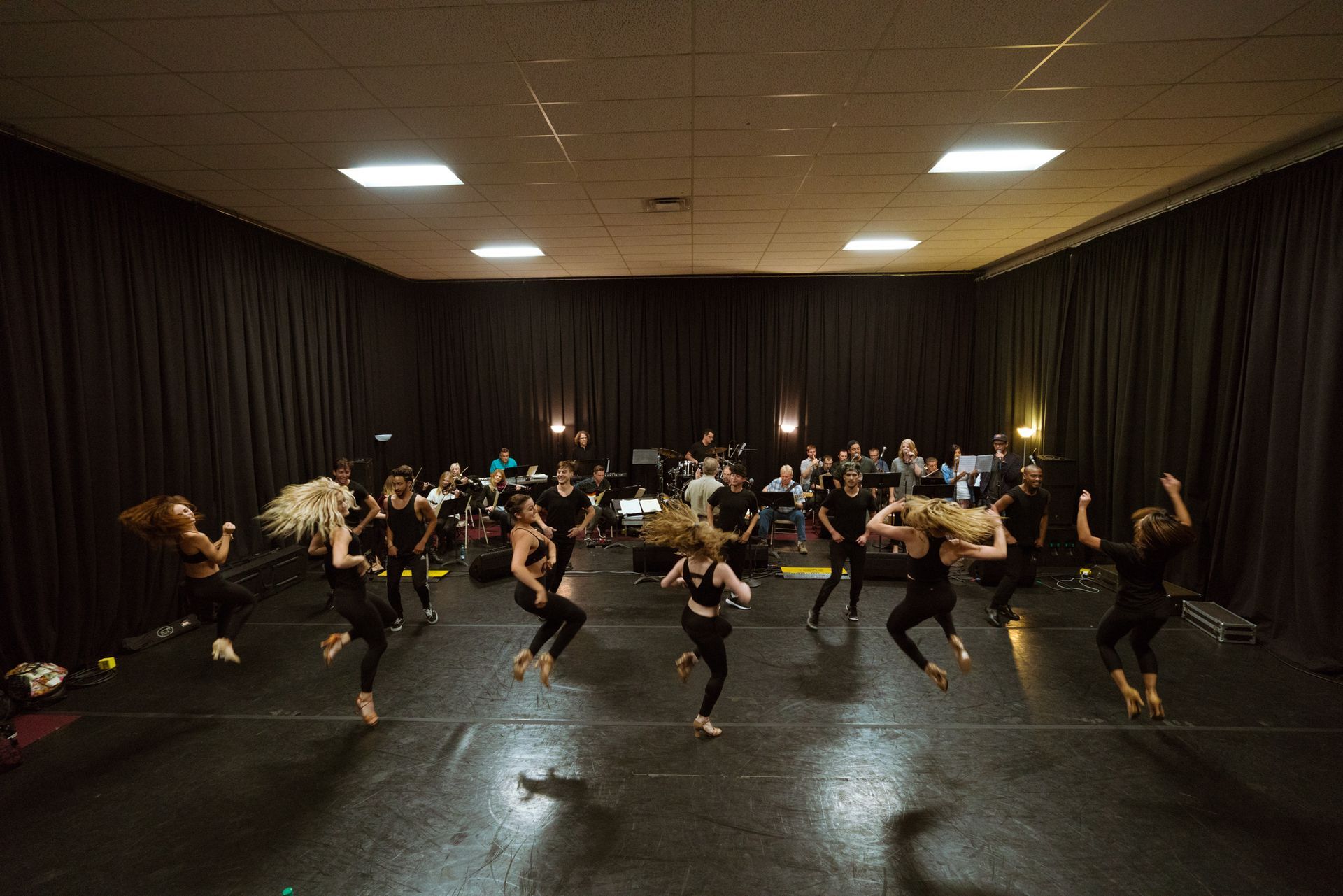 Full dance team rehearsing before private event