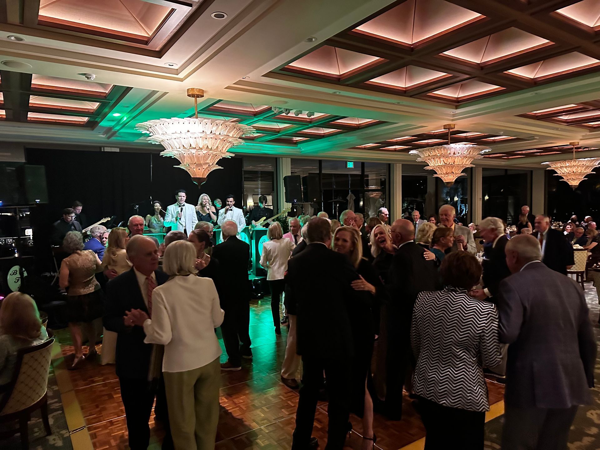 Crowd surfing groom during live band wedding reception