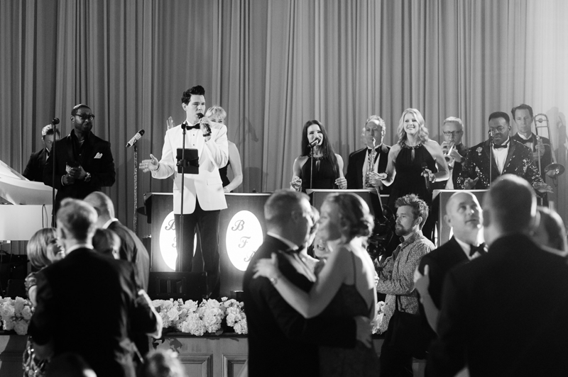 live band performing on stage in black and white
