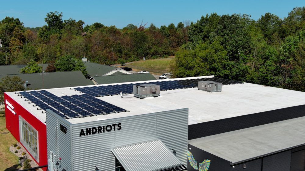 Building rooftop with solar panels, the word 