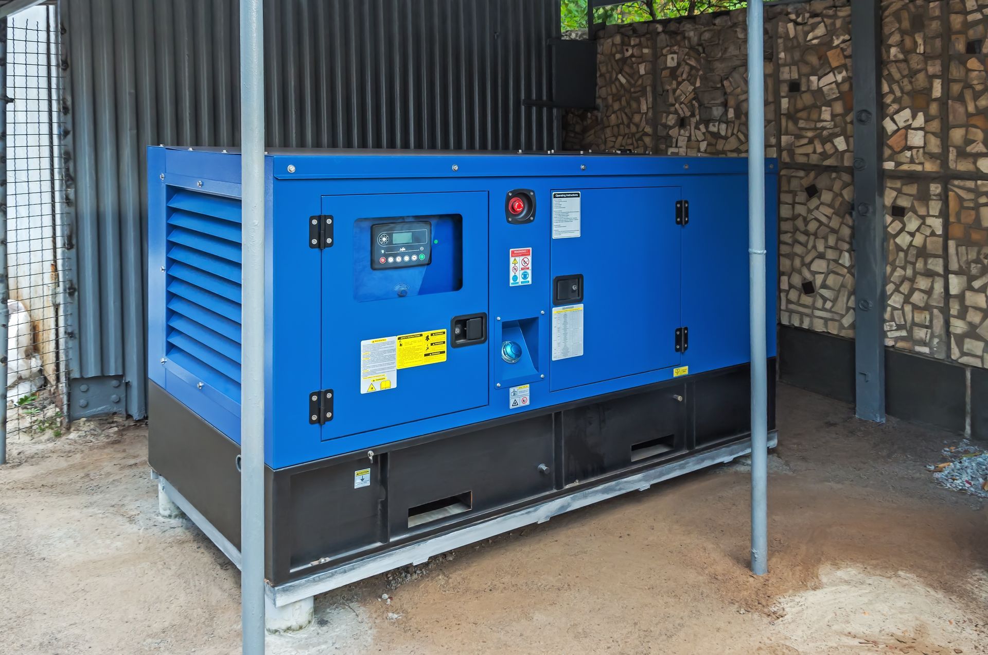 Blue generator in a shelter with a control panel.
