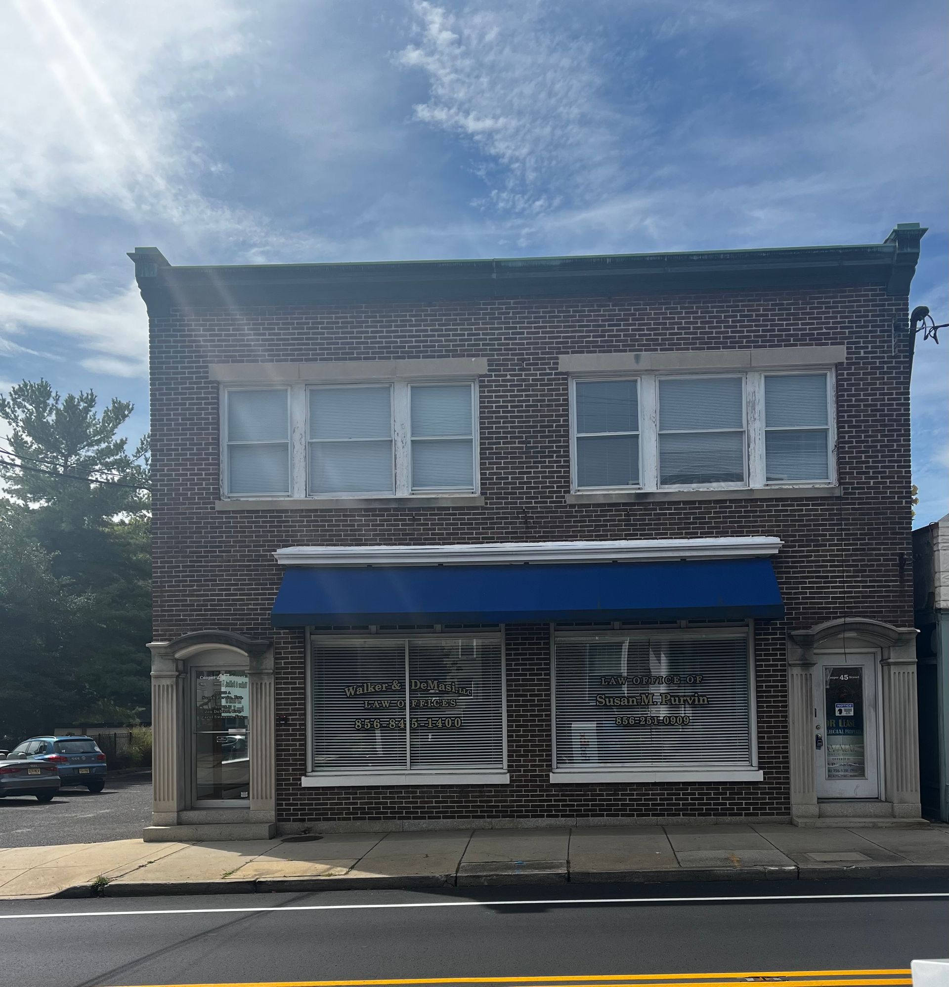 A brick building with a blue awning on the front A brick building with a blue awning on the front
