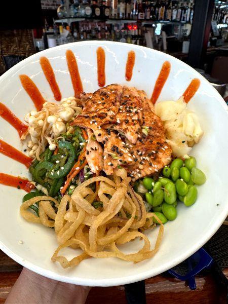 A plate of seared salmon with jalapenos and truffle