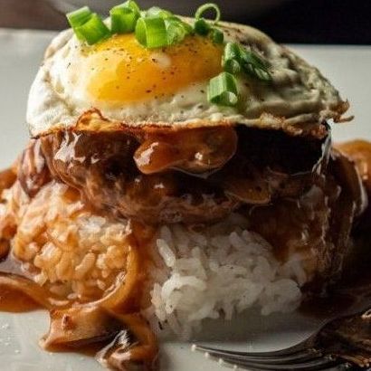 A plate of food with rice and a fried egg on top called Loco Moco