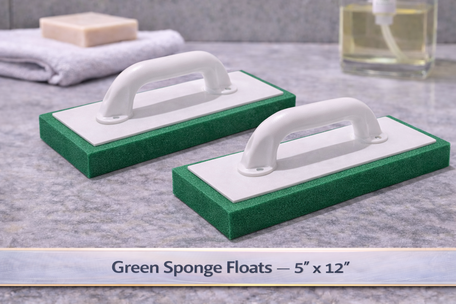 Two green sponge floats with white handles on a gray surface