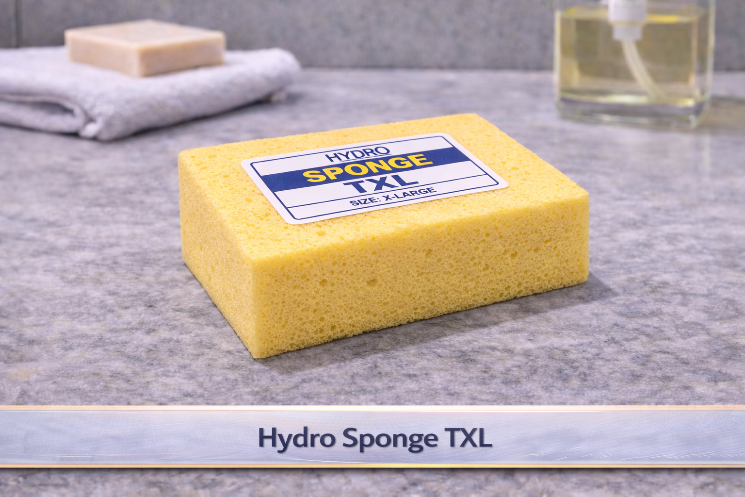Yellow sponge block labeled “Hydro Sponge TXL” on a countertop with a sink in the background