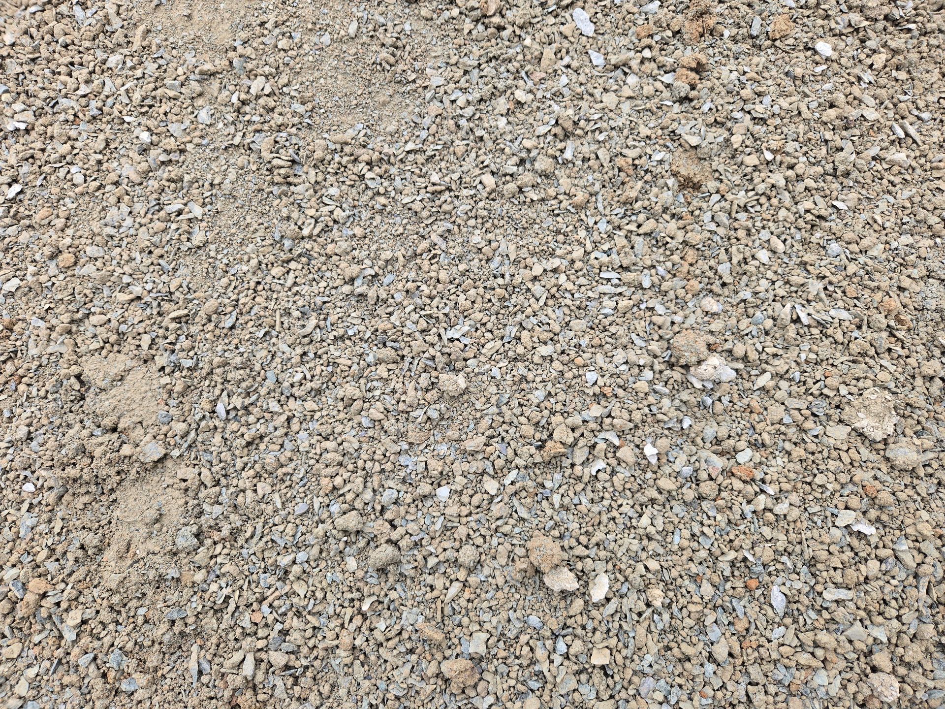 Close-up of rough gray and tan gravel stones covering the ground
