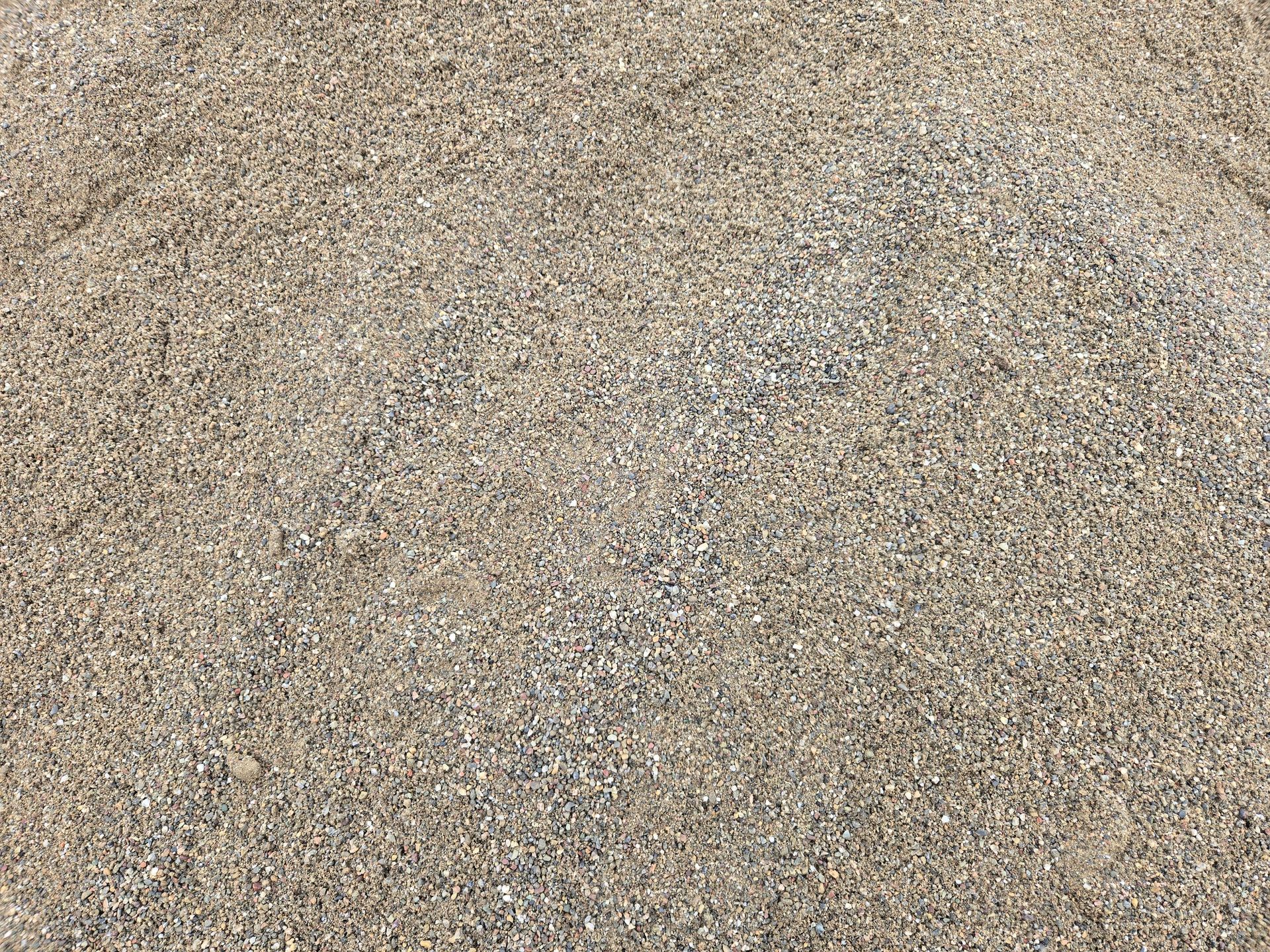 Close-up of a beige and gray pebbled surface with a rough, grainy texture