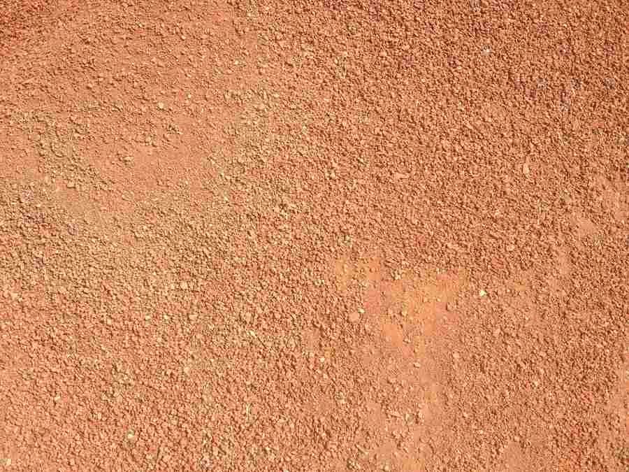 Close-up of a rough orange-brown textured surface with subtle lighter patches