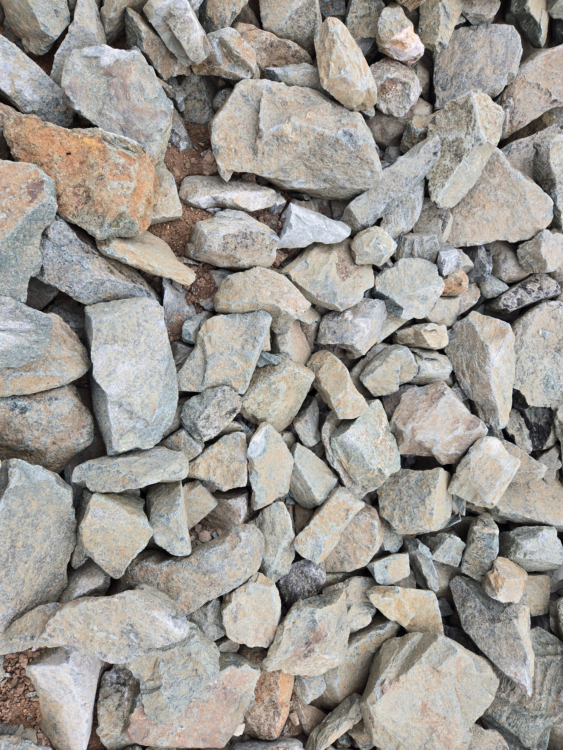 Close-up of small gray and tan gravel stones filling the frame