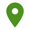 Une épingle de carte verte avec un cercle blanc au milieu sur un fond blanc.