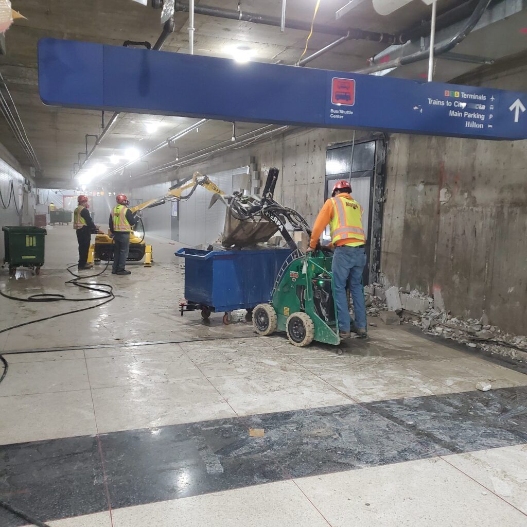A group of construction workers are working in a subway station