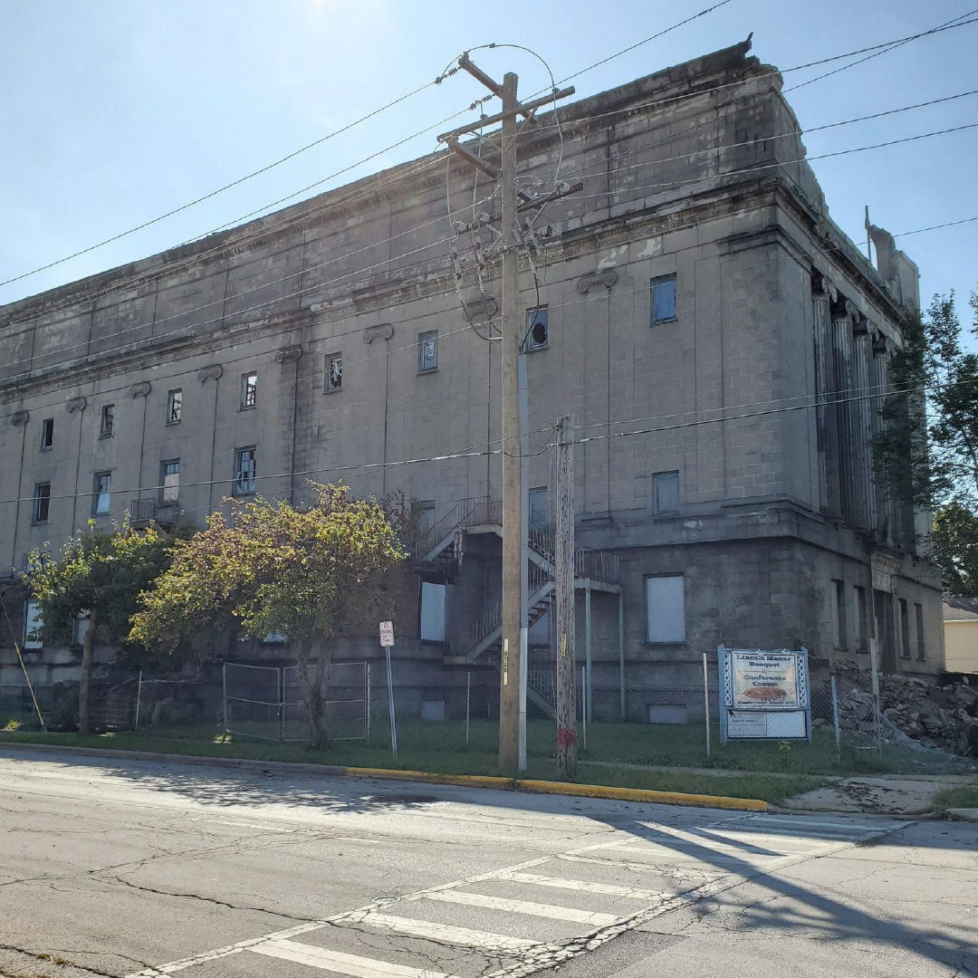 A large building with a telephone pole in front of it