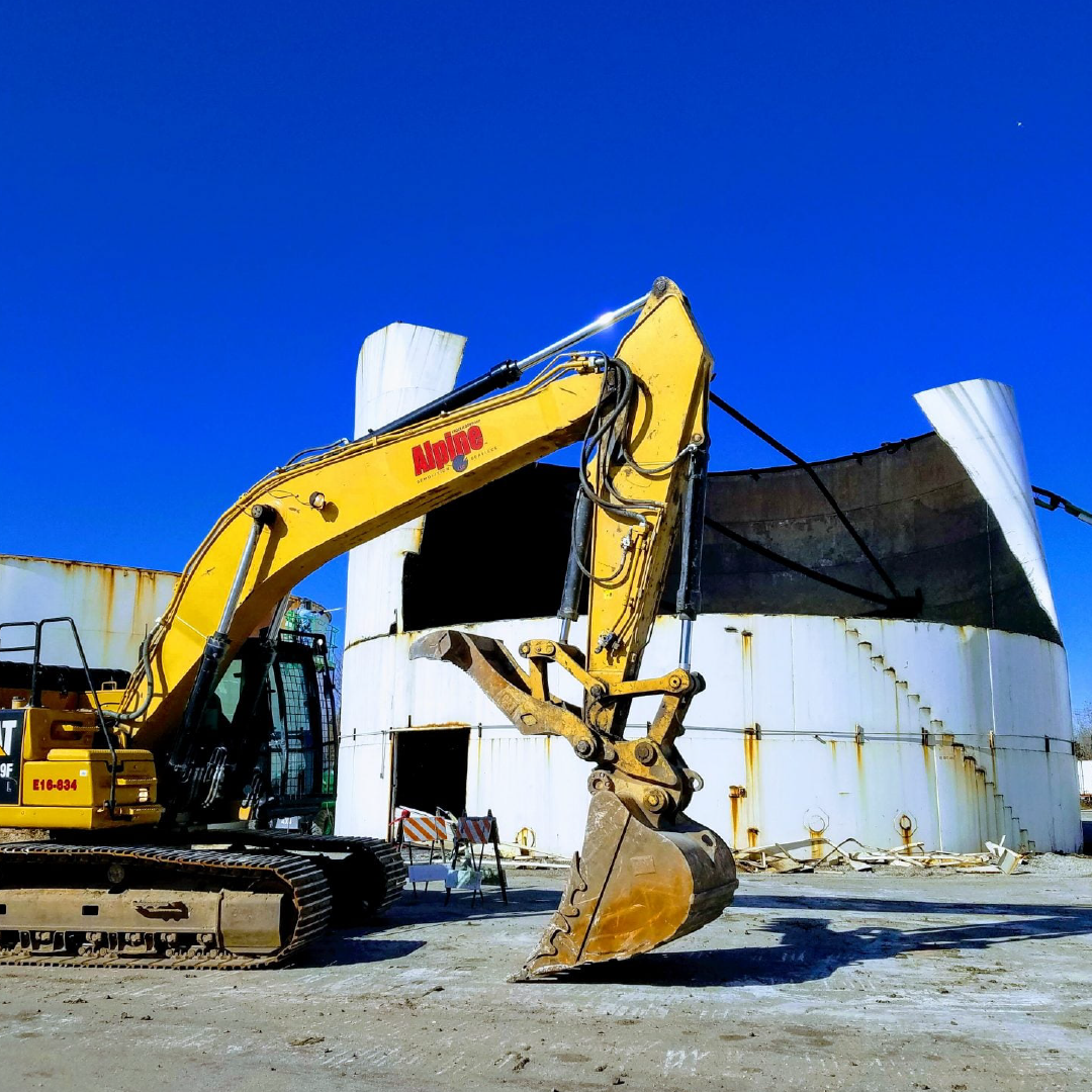 A yellow excavator with the word cat on it