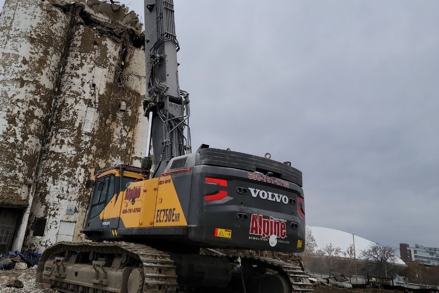 A large excavator is being used to demolish a building.