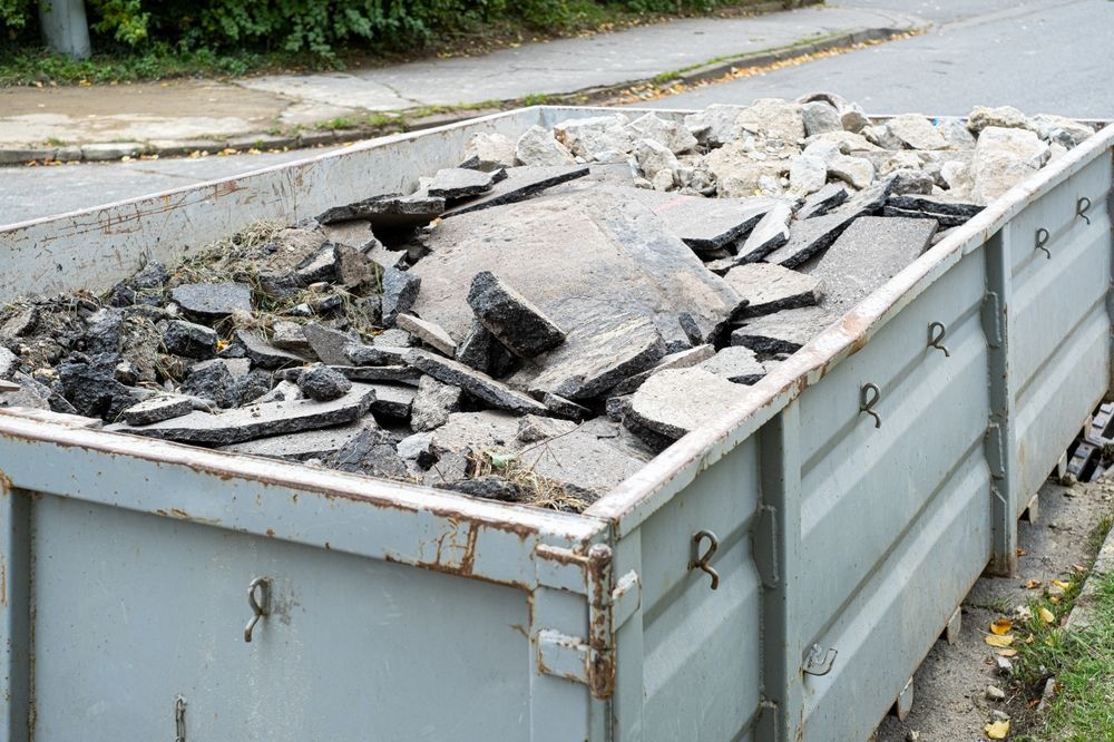 large metal recepticle for collecting crushed concrete to be made into base layers as a part of green demolition