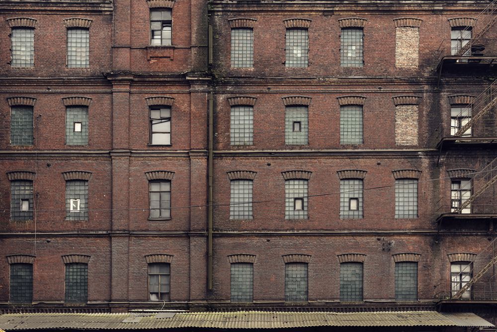 An old brick building with many windows and a fire escape