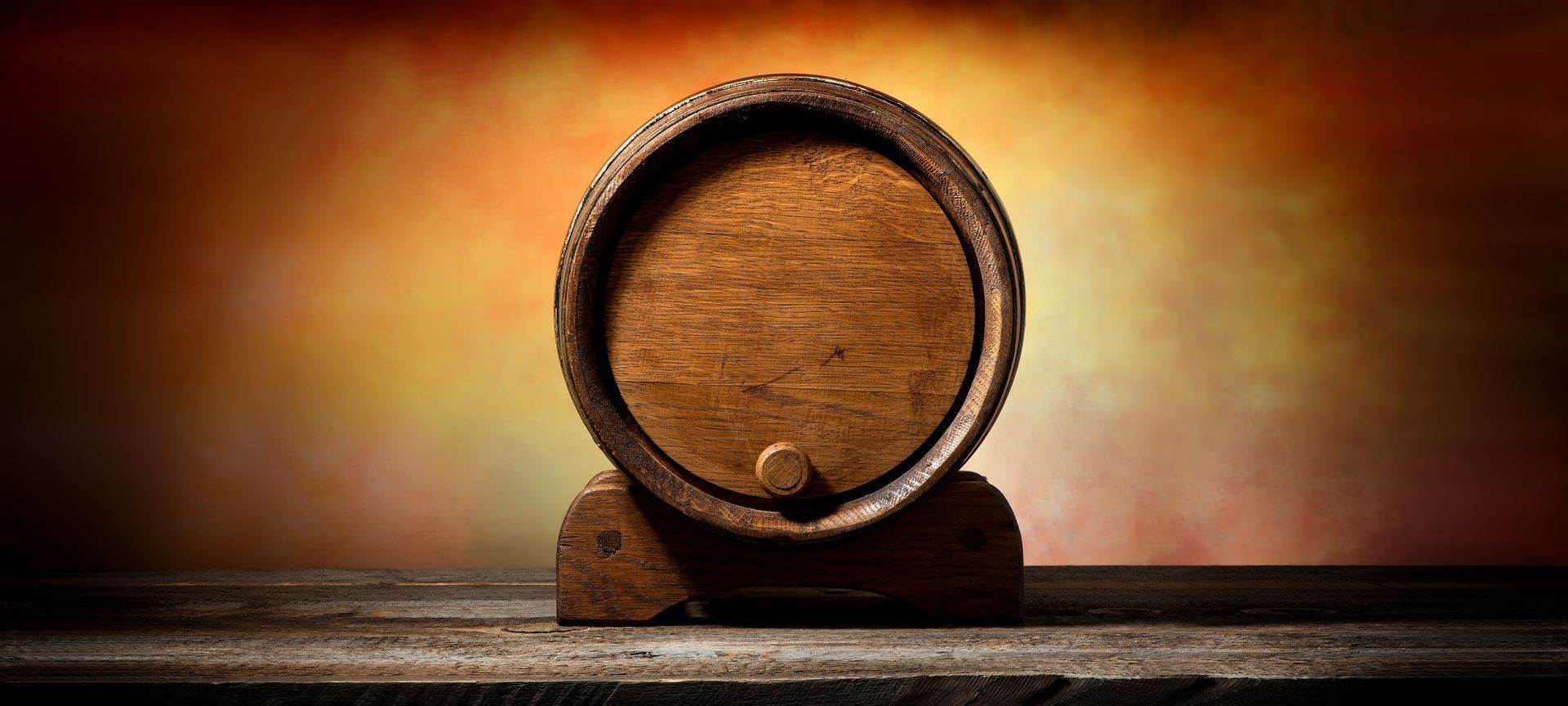 a wooden barrel is sitting on top of a wooden table .