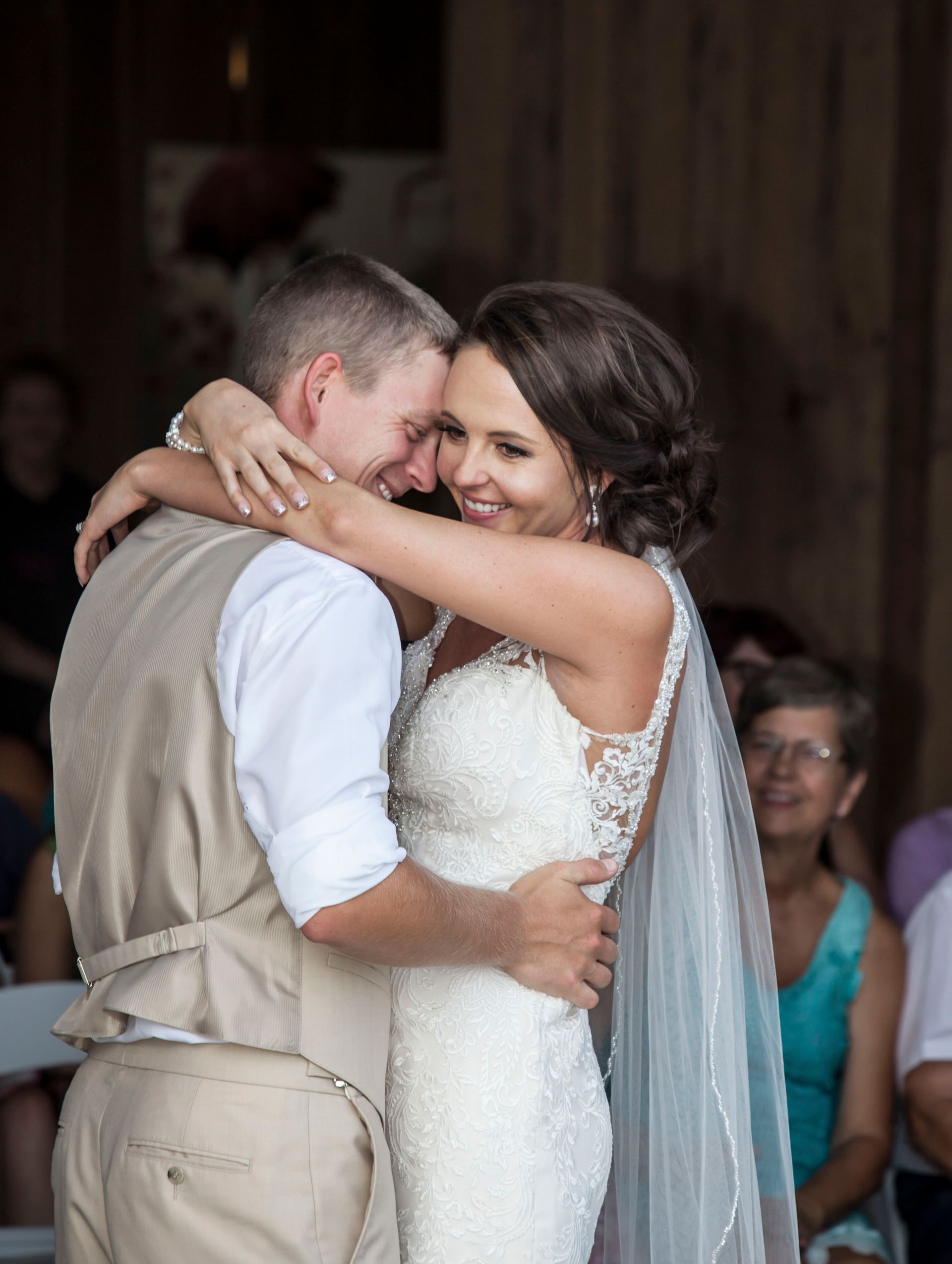 Bride and groom embracing and smiling during a wedding reception