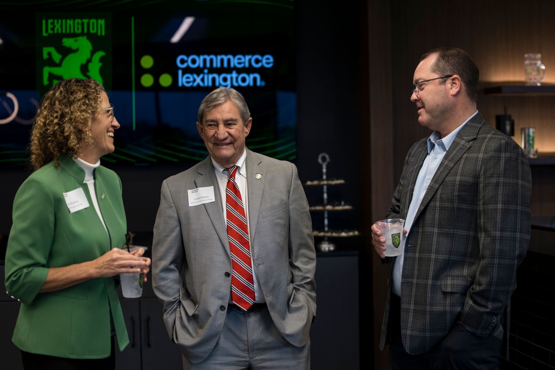 Three people chatting at a Commerce Lexington event on a stage with a black backdrop