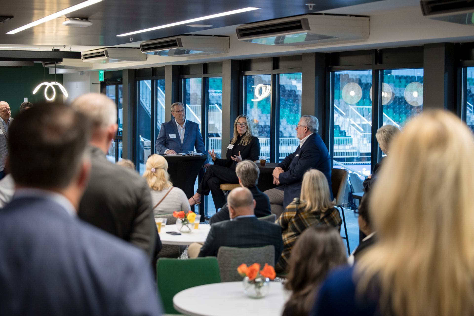 Conference audience watching a panel discussion in a modern office space