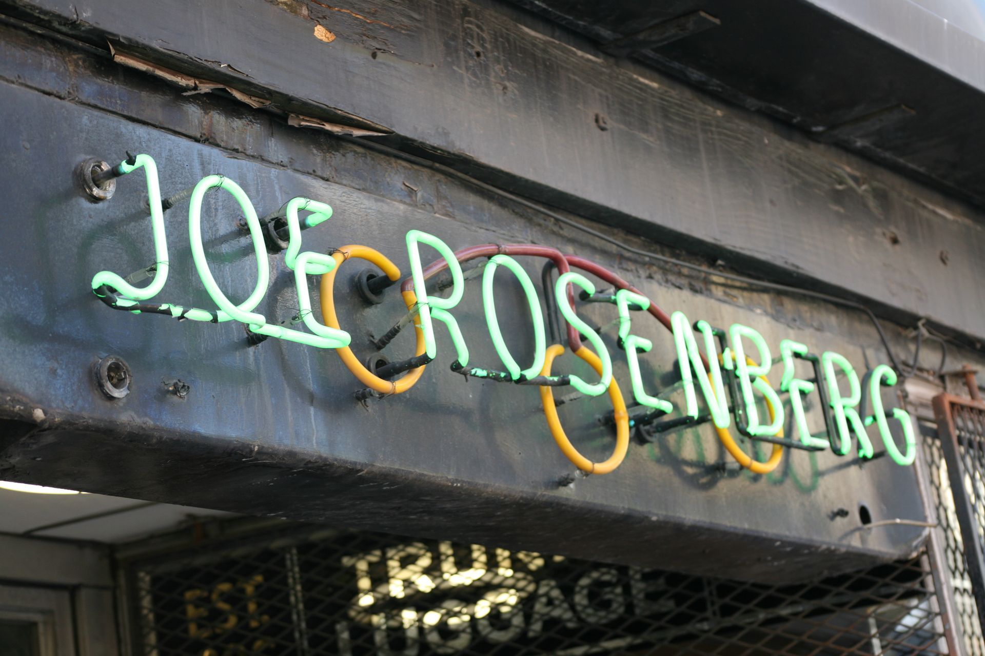 Joe Rosenberg sign on a storefront, in green and yellow lettering