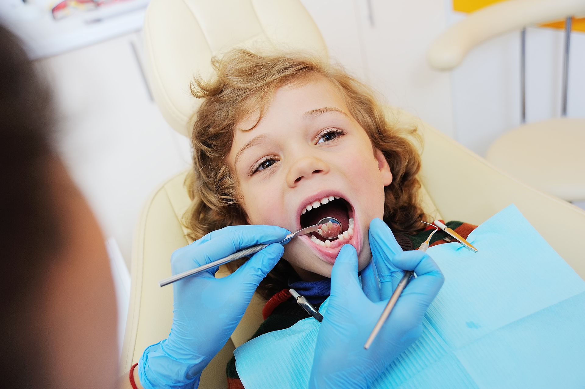 Boy Is Sitting in A Dental Chair 