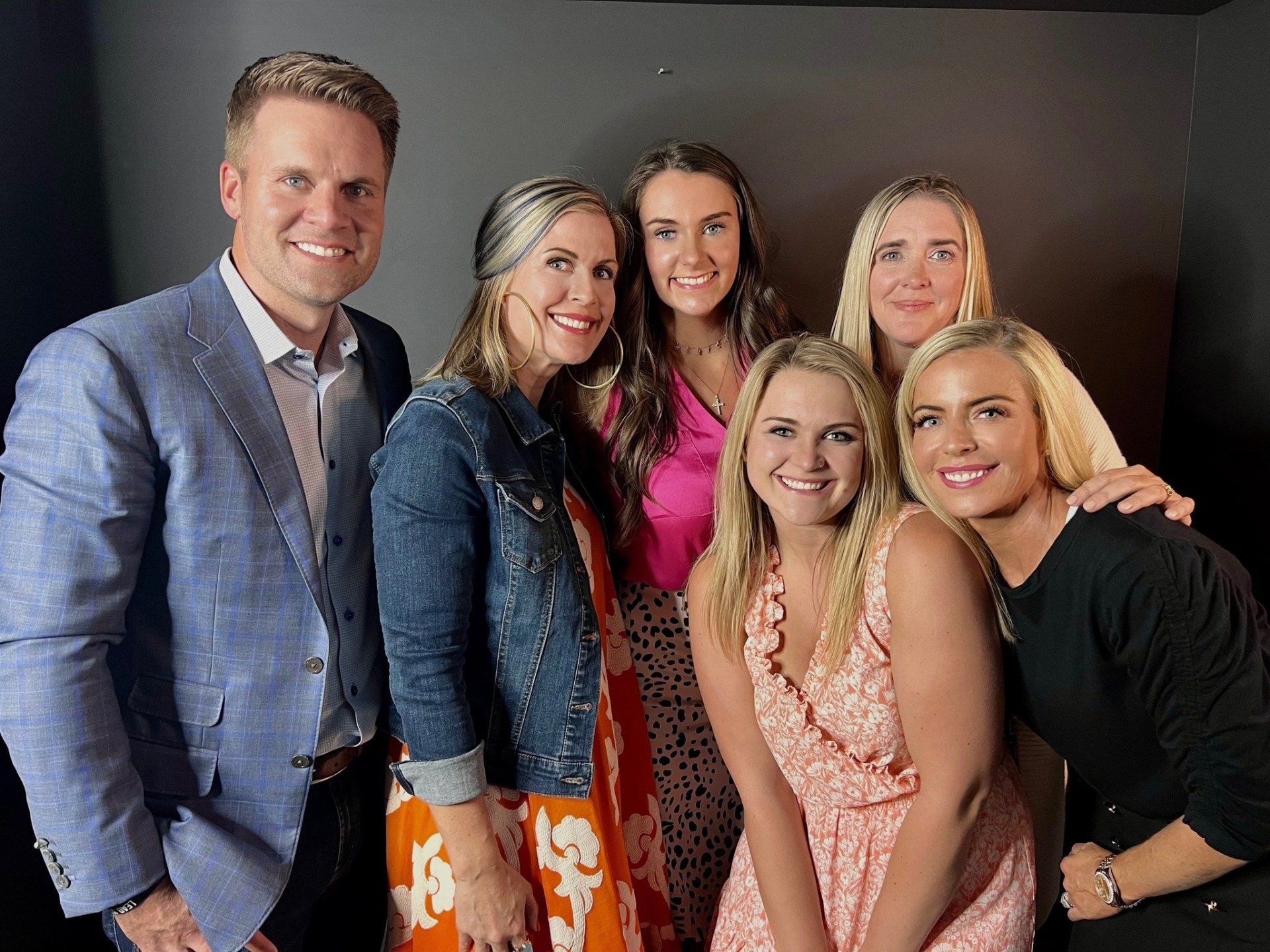 A group of people are posing for a picture and smiling