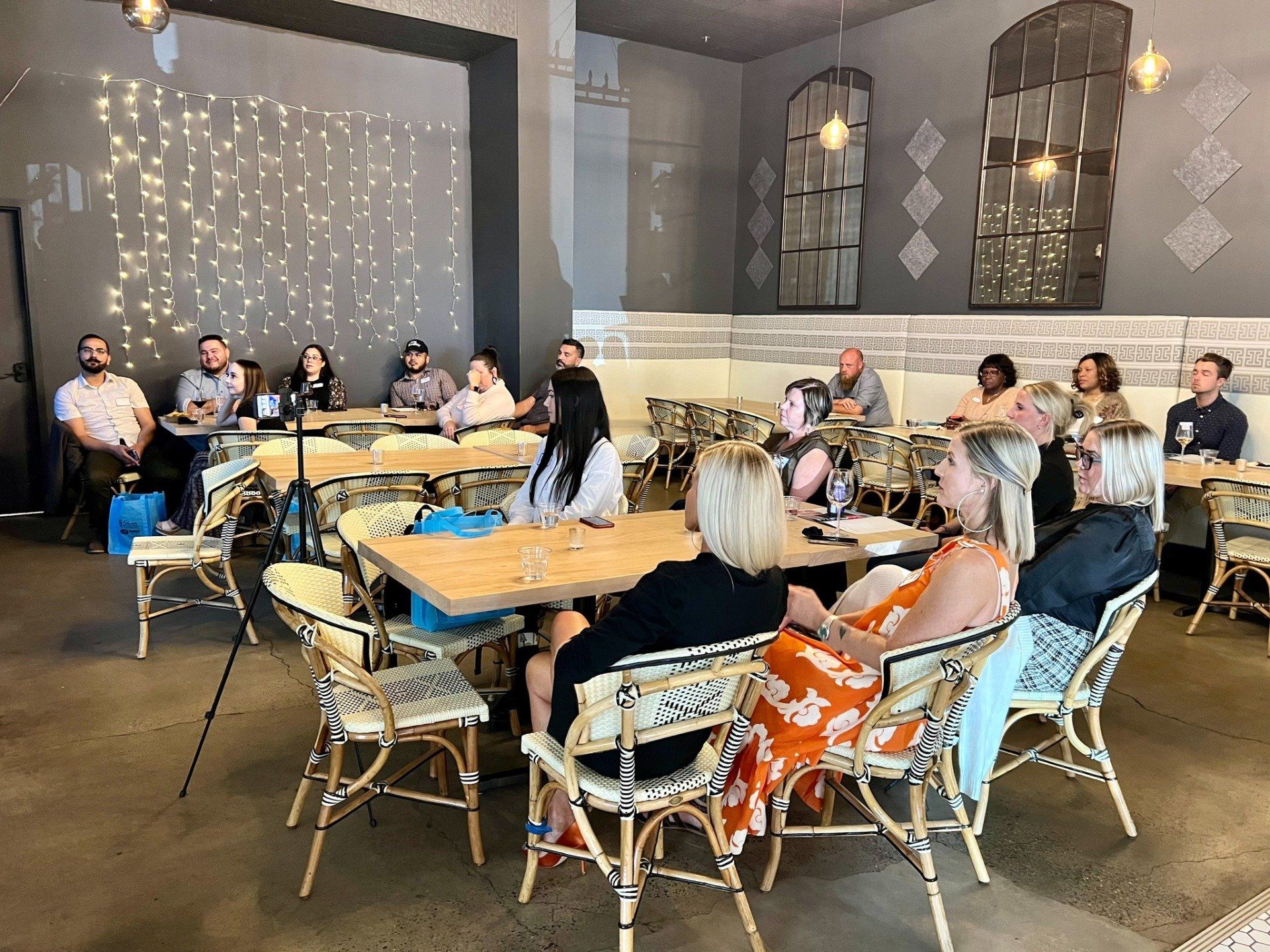 A group of people are sitting at tables in a restaurant