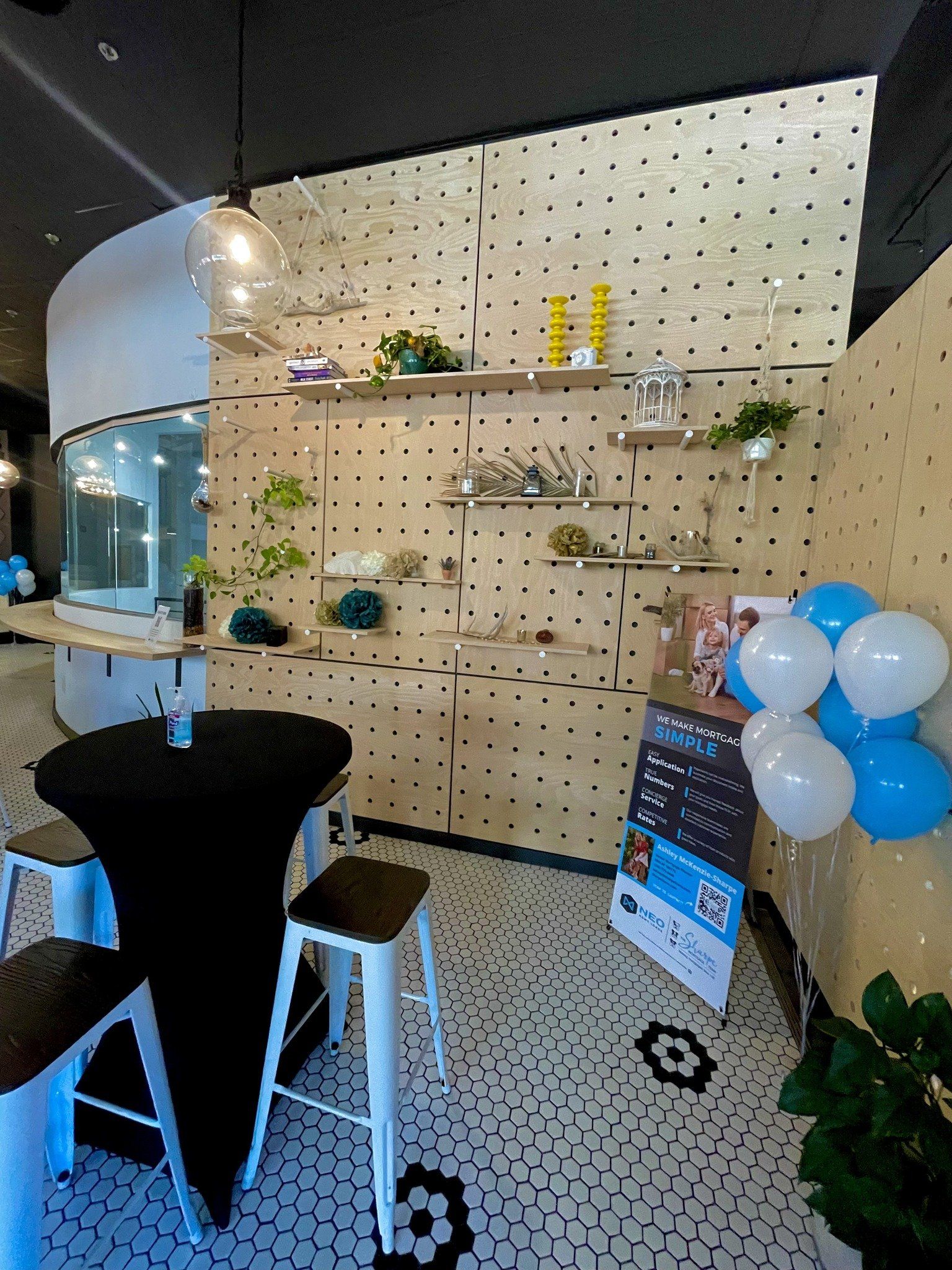 A room with tables and chairs and balloons on the floor