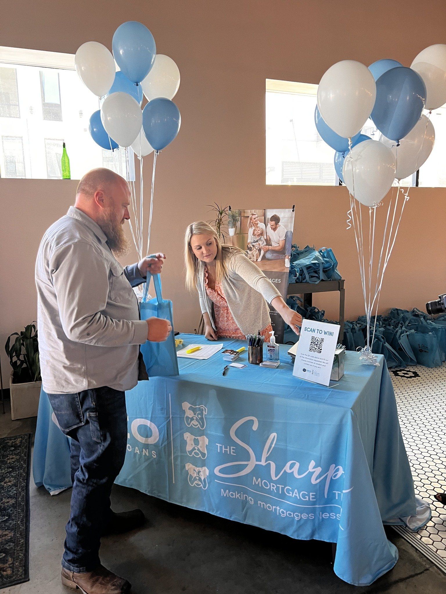 A man and a woman standing in front of a table that says sharp