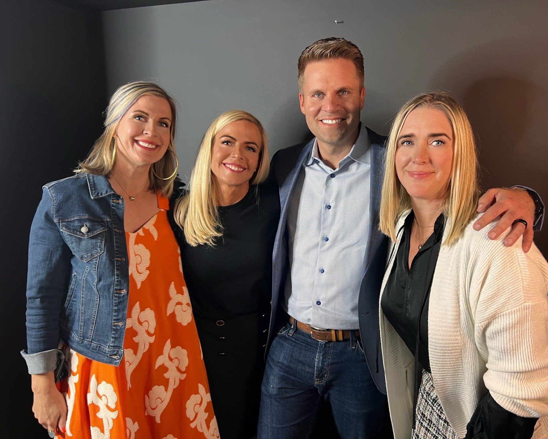 A man and three women pose for a picture together