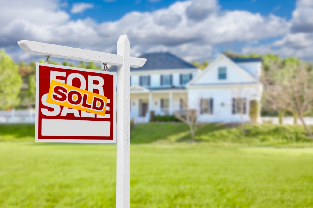 A for sale sign in front of a house