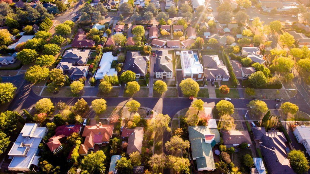 An aerial view of a residential area with lots of houses and trees