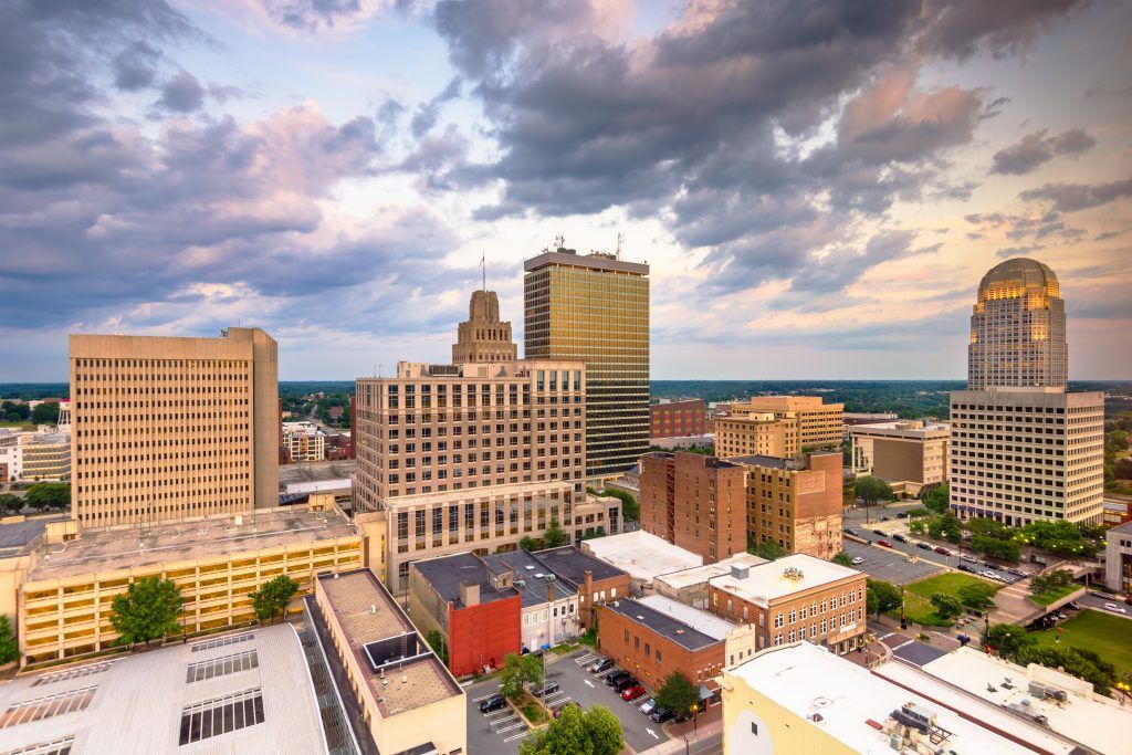 An aerial view of a city with a cloudy sky