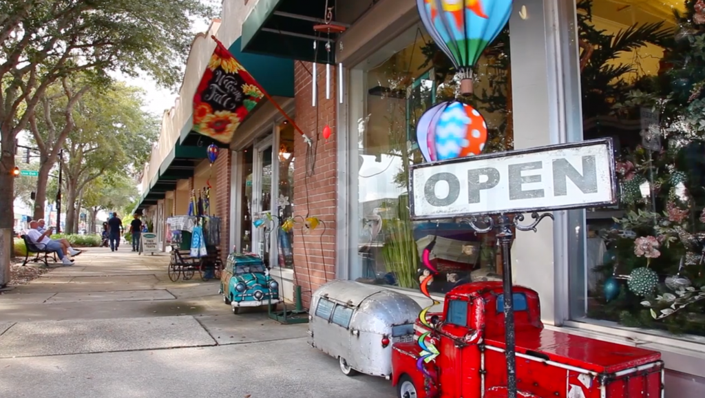 A store front with a sign that says open
