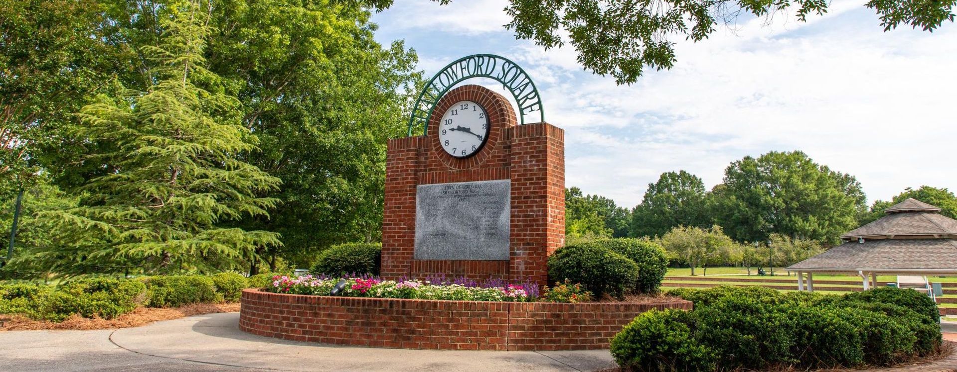 A brick monument with a clock on top of it