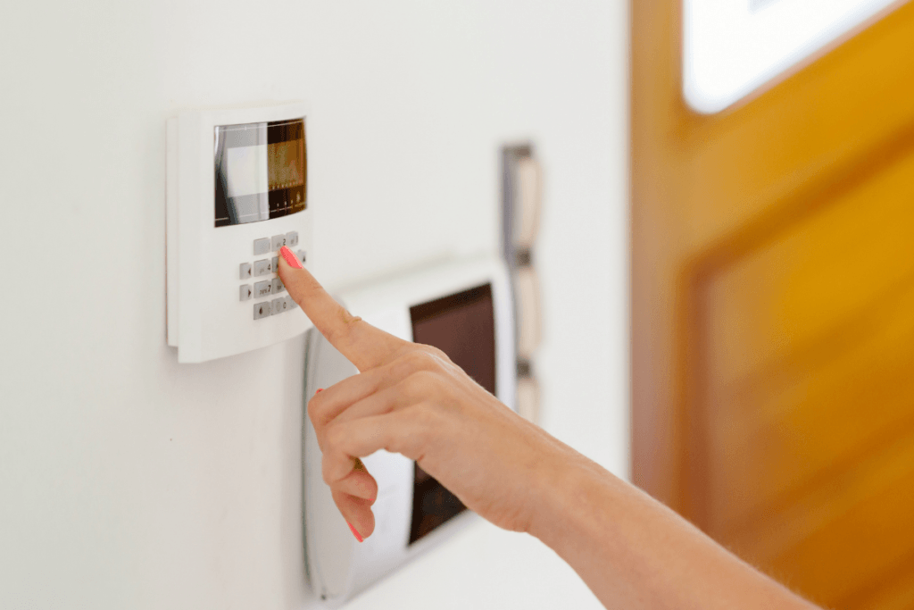 A person is pressing a button on a security system