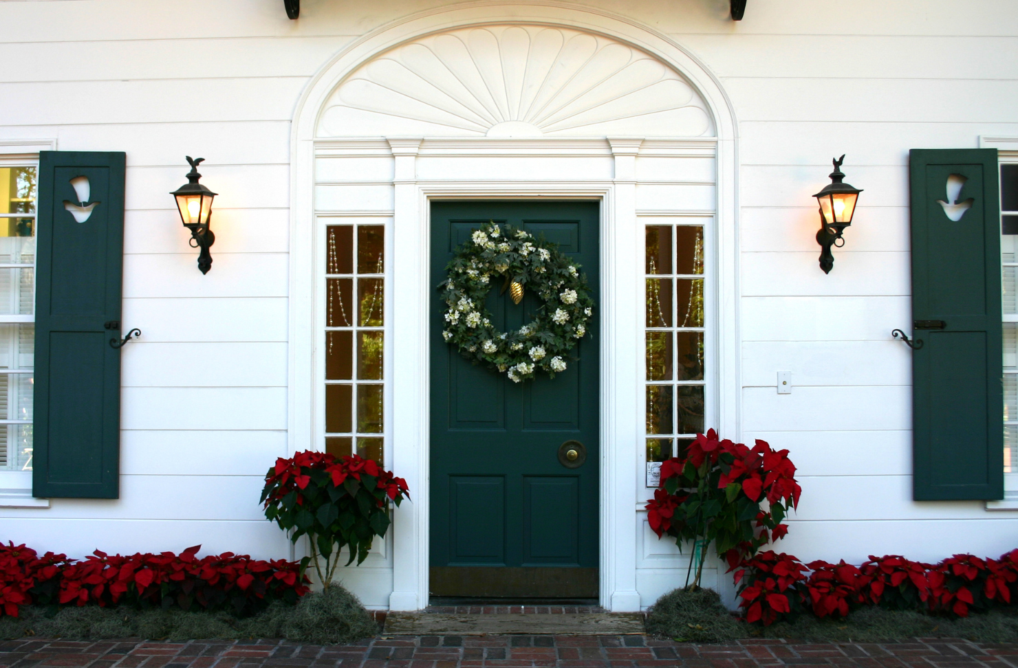 The front door of a house with a wreath on it