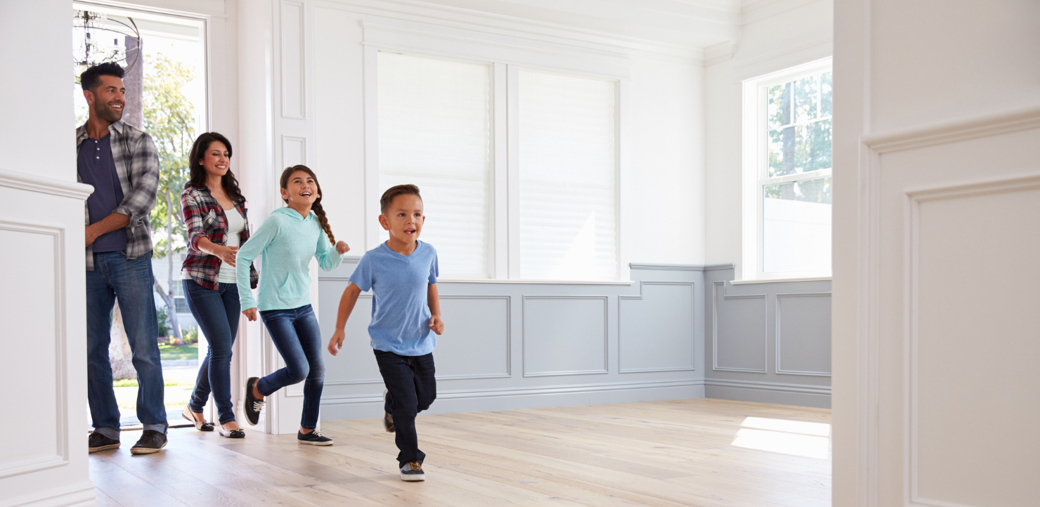 A family is walking through an empty house.