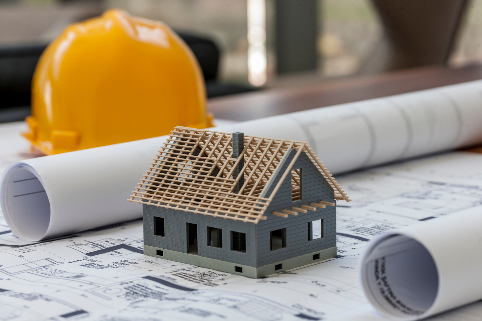 Home construction framing and blueprints representing experienced construction lending support in North Carolina
