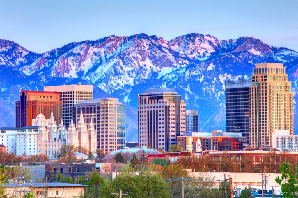 A city skyline with mountains in the background