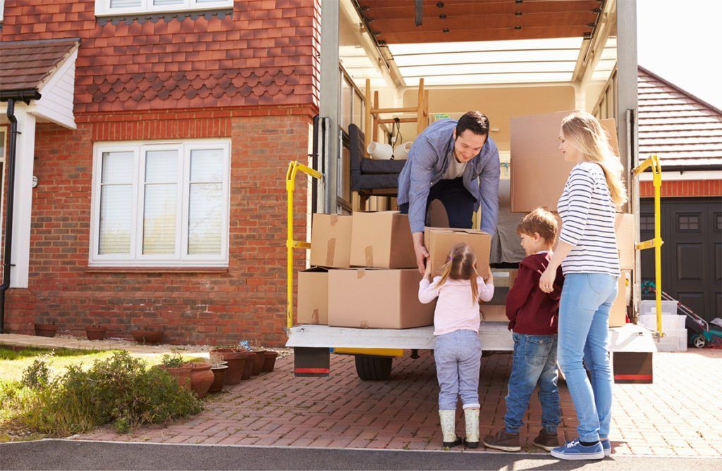 A family is loading boxes into a moving truck