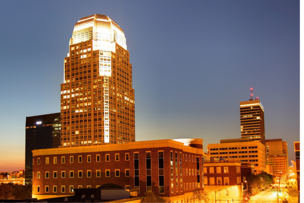 A very tall building is lit up at night